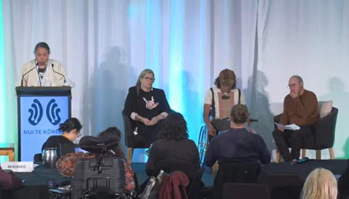 From left: Rāhera Turner, Rodney Bell and Stace Robertson sit on-stage next to the Nui te Kōrero podium. 